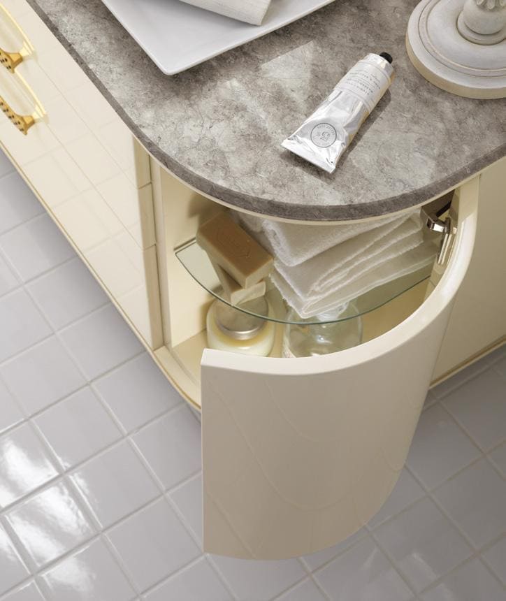 Curved bathroom cabinet door open, revealing neatly stacked towels and toiletries on glass shelves, with a marble countertop above.