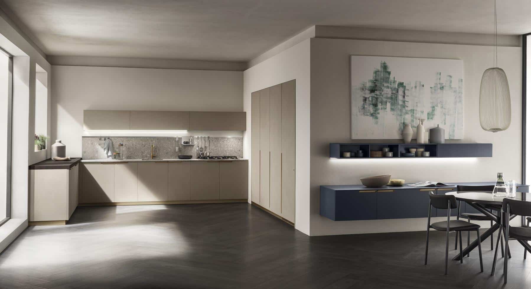 Modern kitchen and dining area with light wood cabinets, minimalist decor, dark wood flooring, a dining table with chairs, and abstract wall art.
