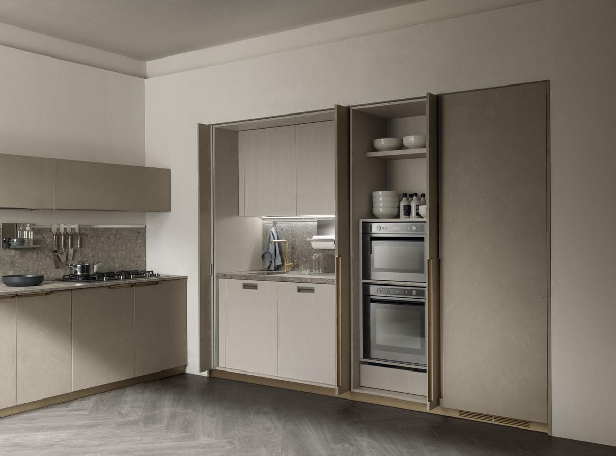 Modern kitchen with neutral tones, featuring a built-in oven, shelves with dishes, and a closed cabinet next to a countertop with a gas stove and backsplash.