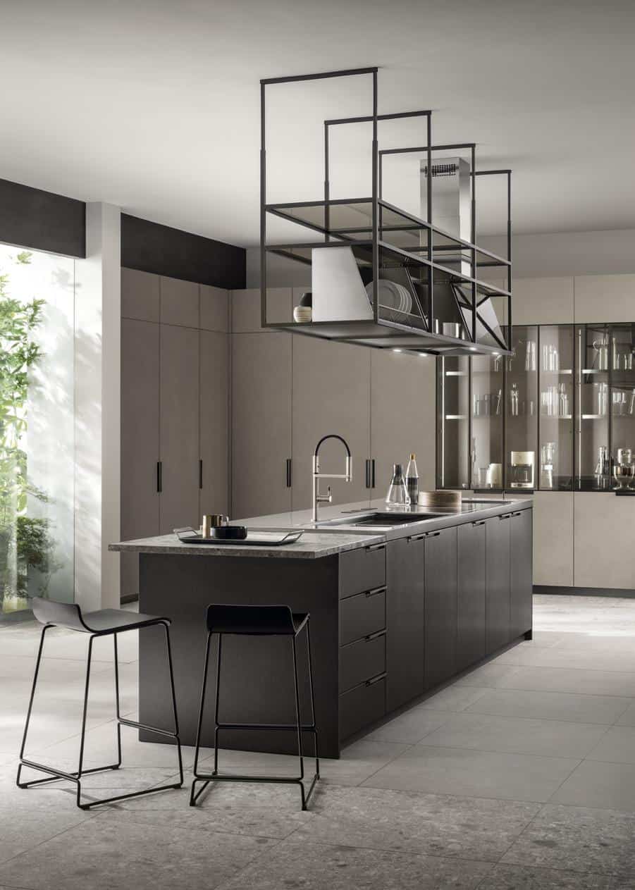 Modern kitchen with a sleek black island, two stools, and suspended shelving.