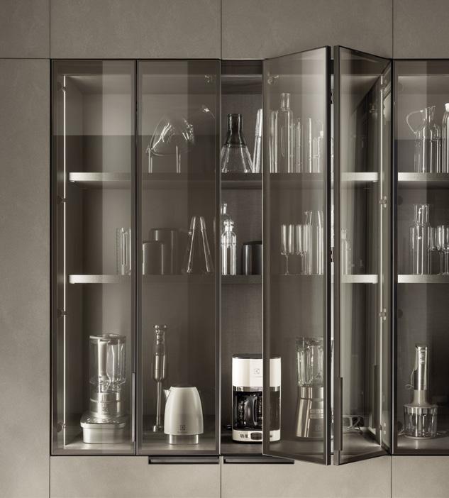 Glass cabinet with kitchen appliances and glassware displayed.