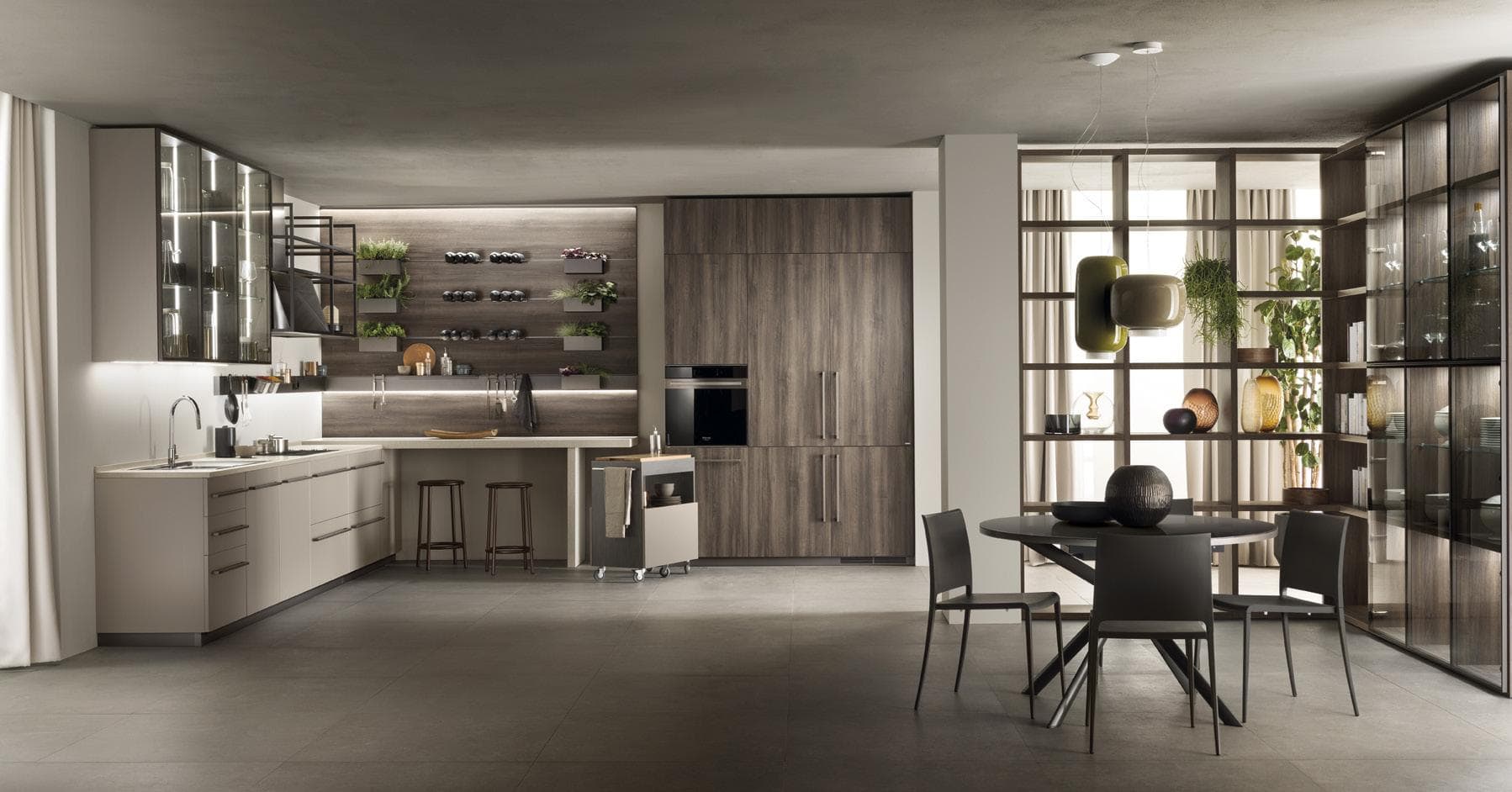 Modern kitchen with dark wood cabinets, open shelving, a dining area with a round table and chairs, and decorative shelving with glassware and plants.