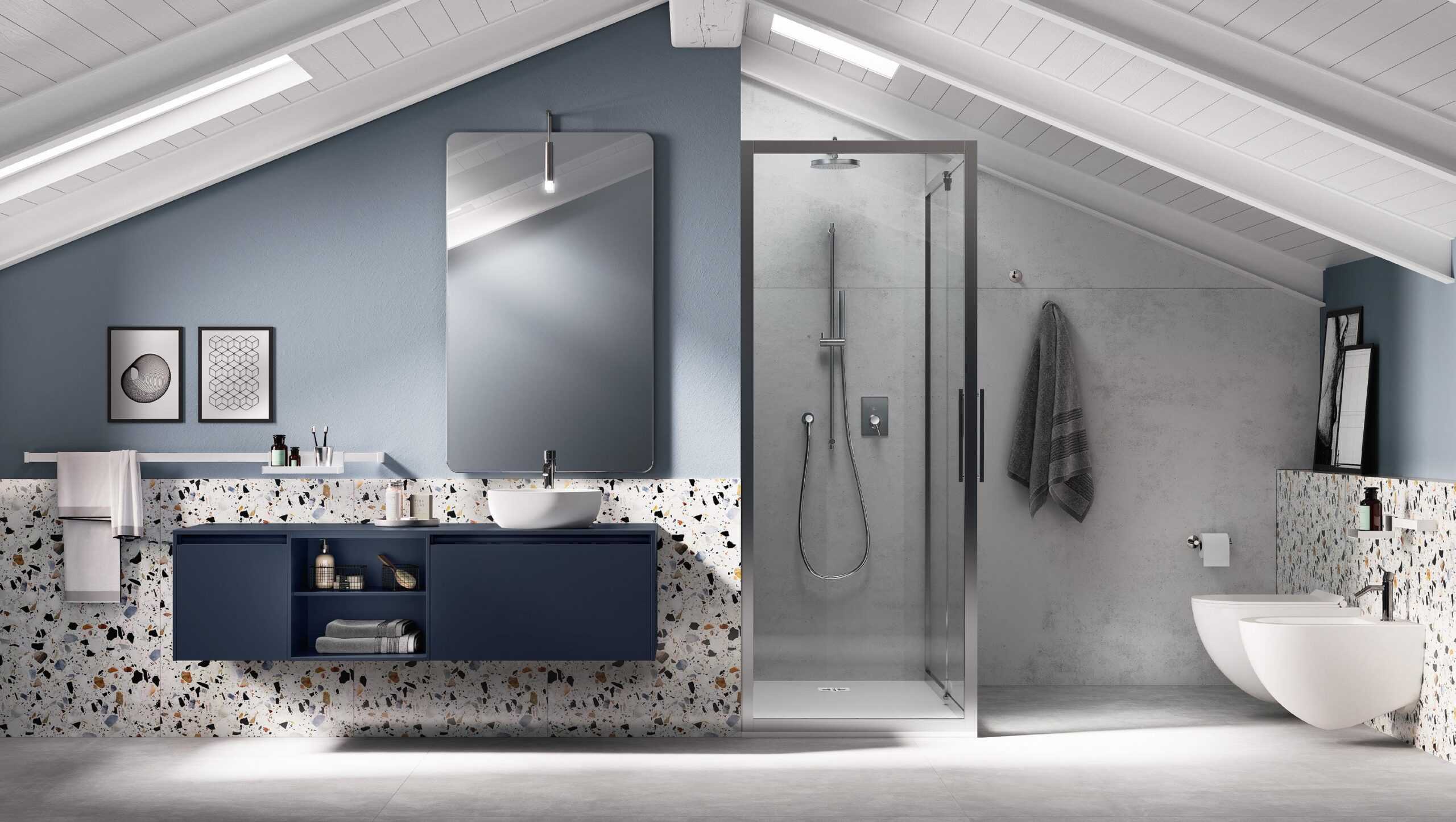Modern bathroom with a blue vanity, large mirror, shower enclosure, bidet, and toilet, set under an angled white ceiling.