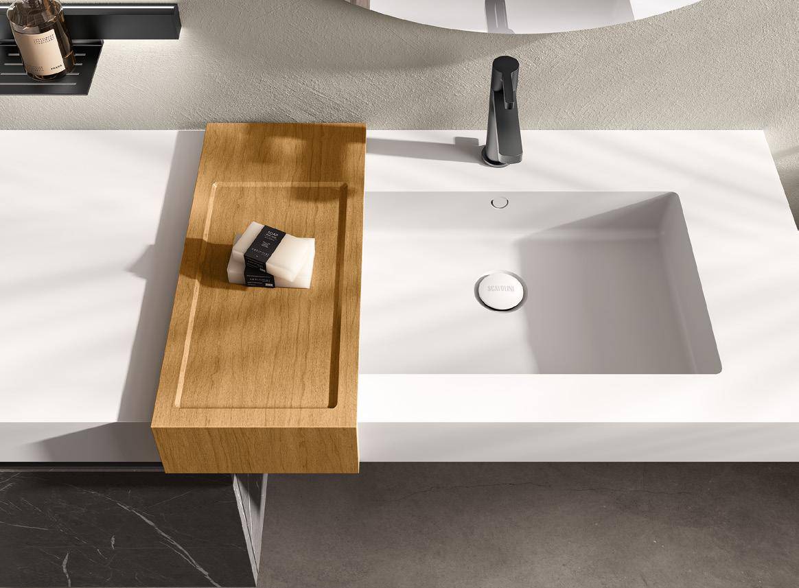 Modern bathroom sink with a wooden soap tray and a black faucet.