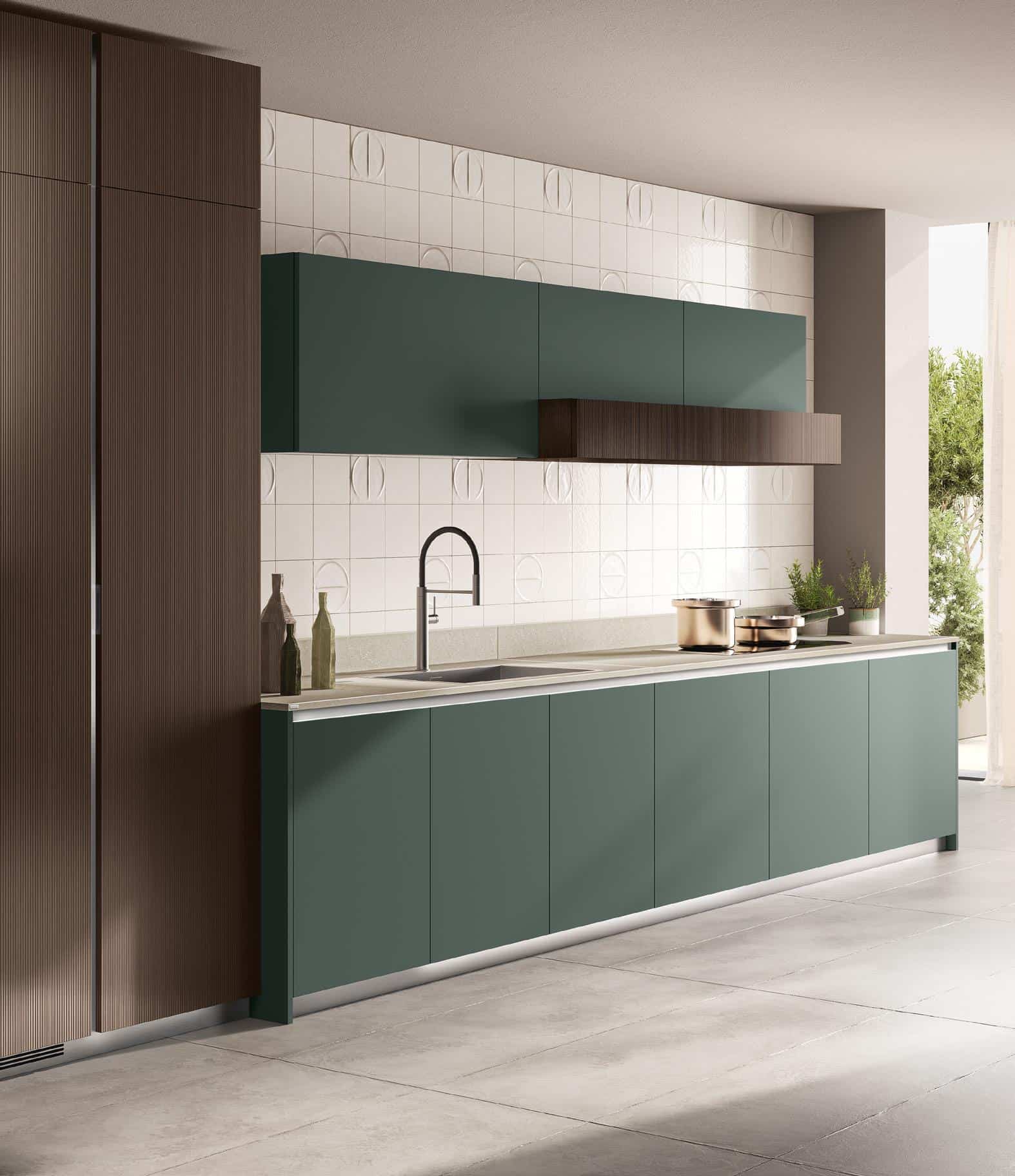 Modern kitchen with matte green cabinets, minimalist faucet, geometric wall tiles, and wooden accents.