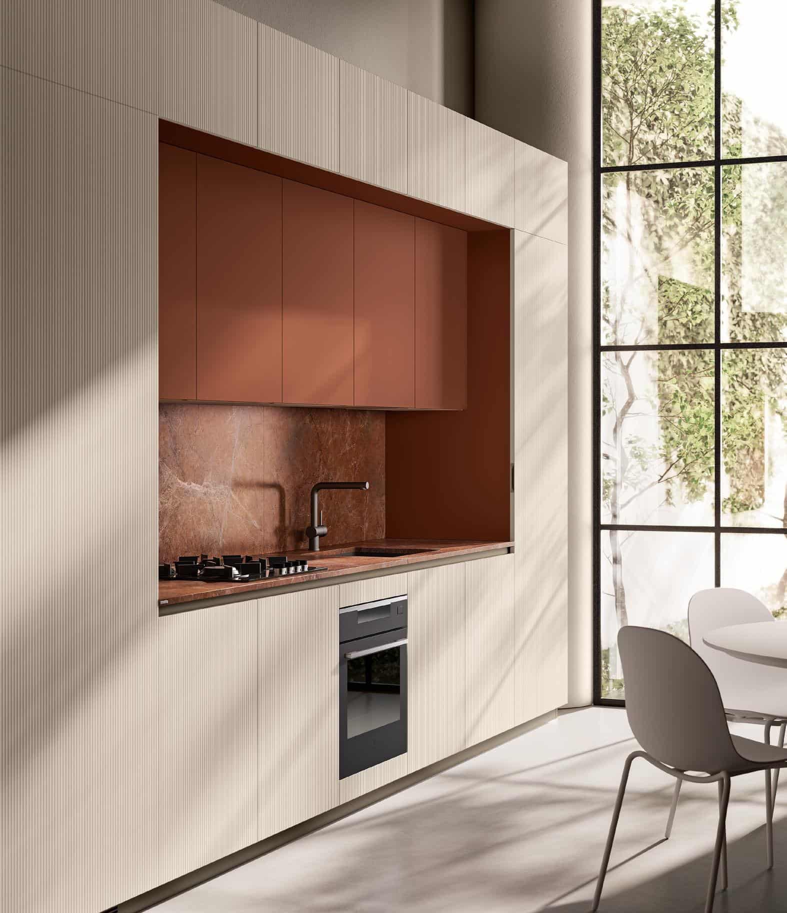 Modern kitchen with integrated beige cabinets, rust-colored backsplash, built-in appliances, and a large window overlooking greenery.