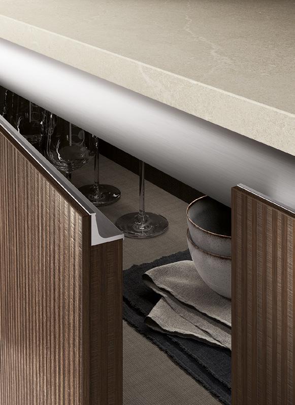Opened kitchen cabinet revealing glassware and stacked bowls on a textured surface.