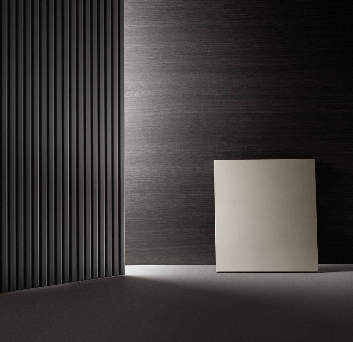 Minimalist interior scene with black textured walls and a white square panel.