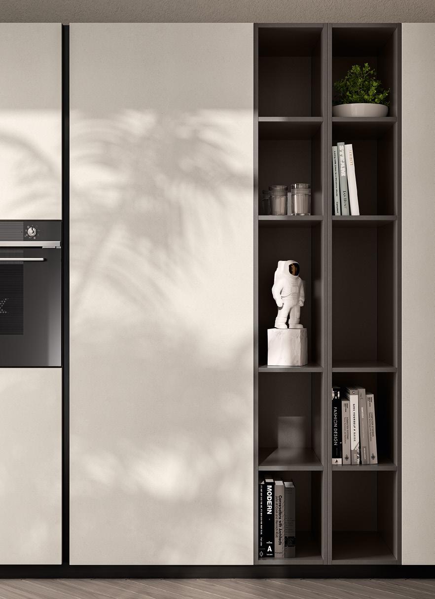 Minimalist kitchen design with built-in oven, open shelves holding books, a plant, jars, and a small astronaut figure.