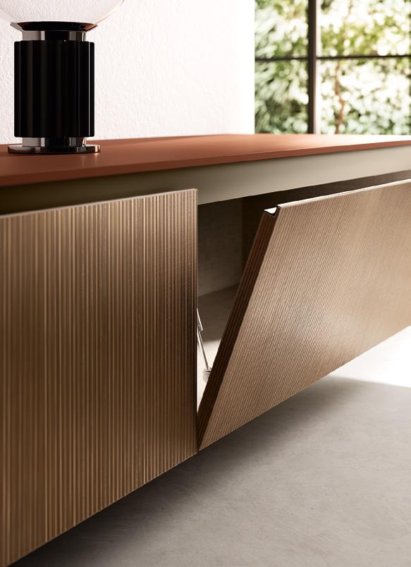 A modern sideboard with ribbed wooden doors, one partially open, and a black lamp on top.