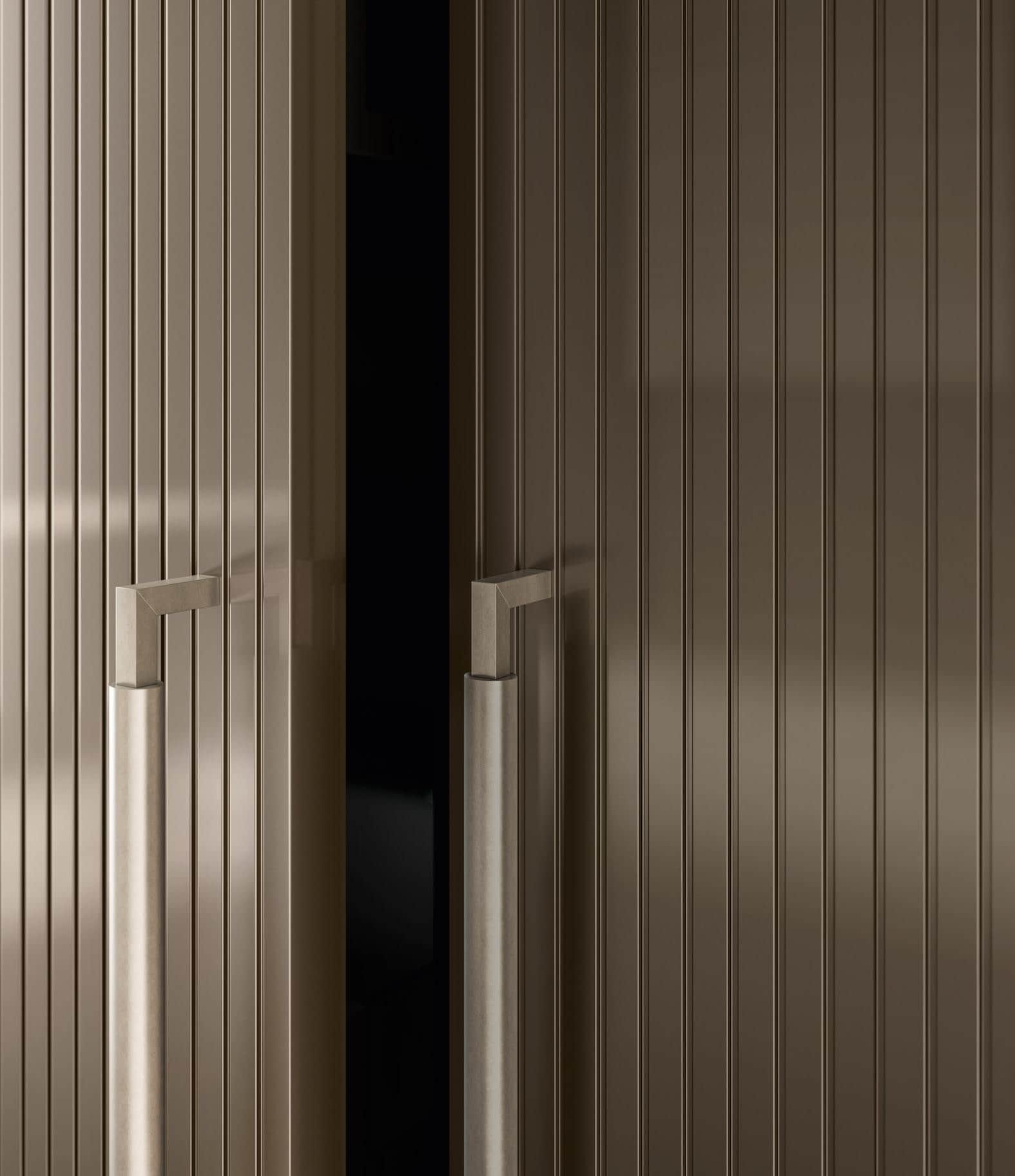 Close-up of partially open, vertically grooved cabinet doors with modern metal handles.