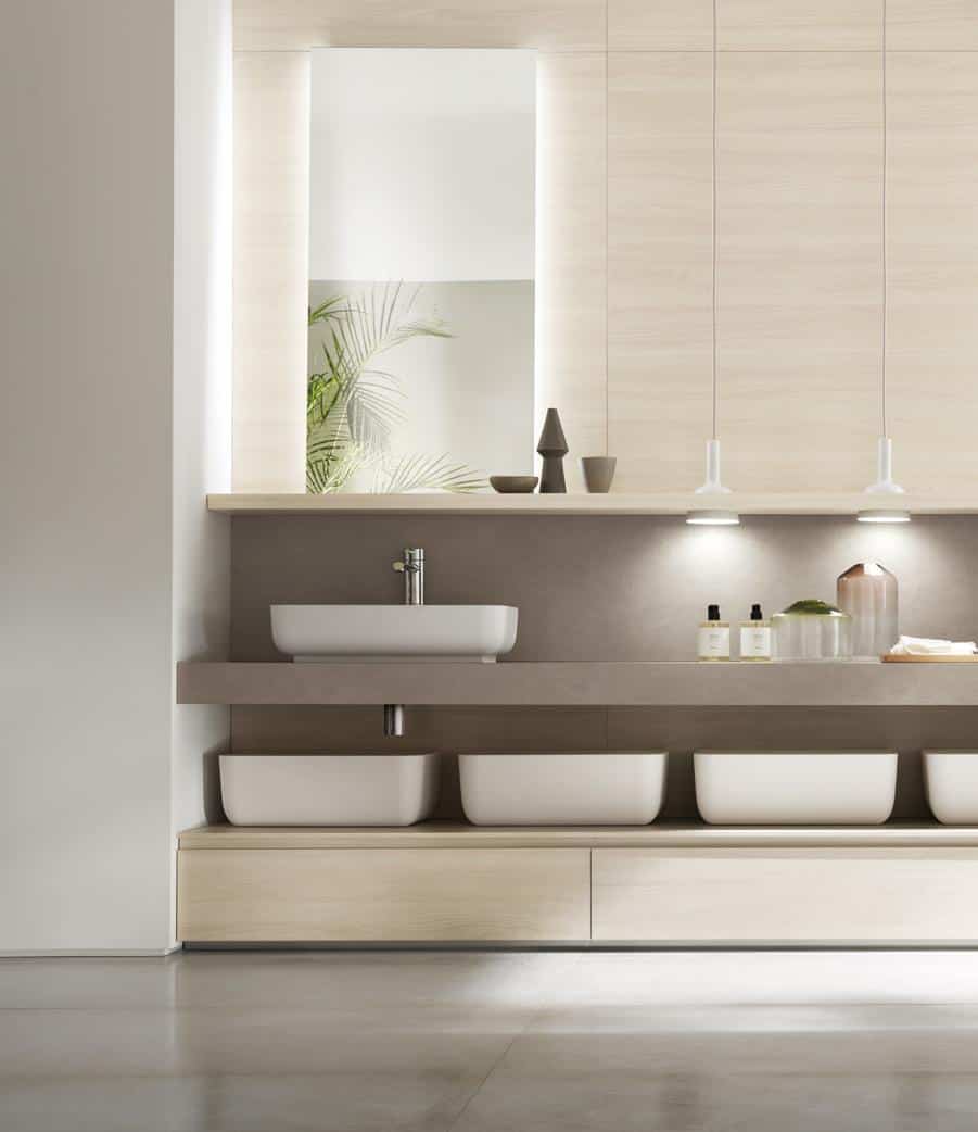 Modern bathroom with a minimalist design, featuring a rectangular sink and wooden cabinetry.