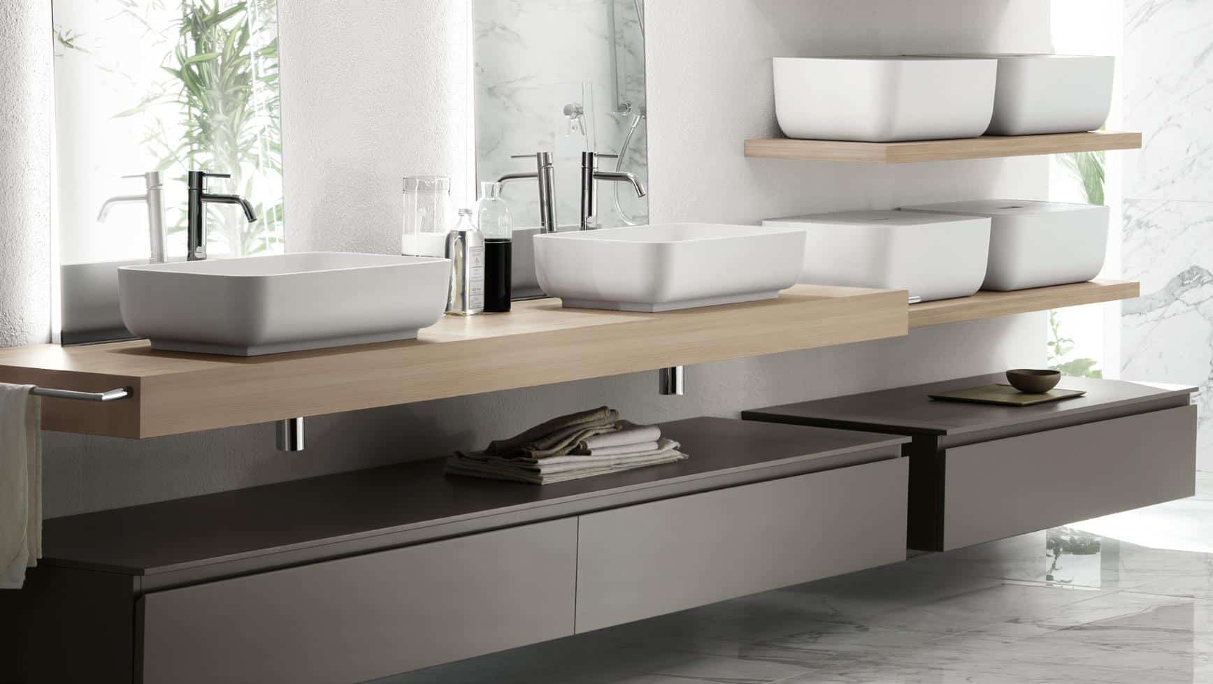 Modern bathroom with double sinks, wooden countertop, and minimalist decor.