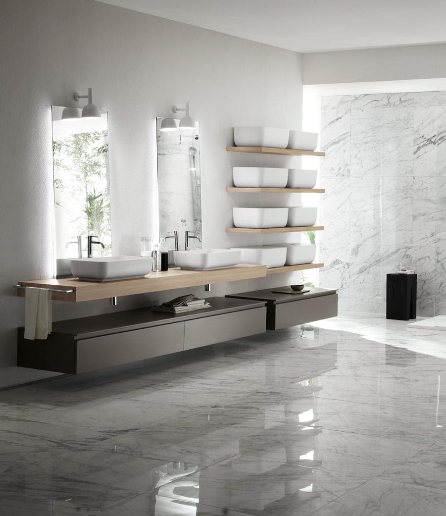 Modern bathroom with double sinks, wall-mounted mirrors, and marble flooring.