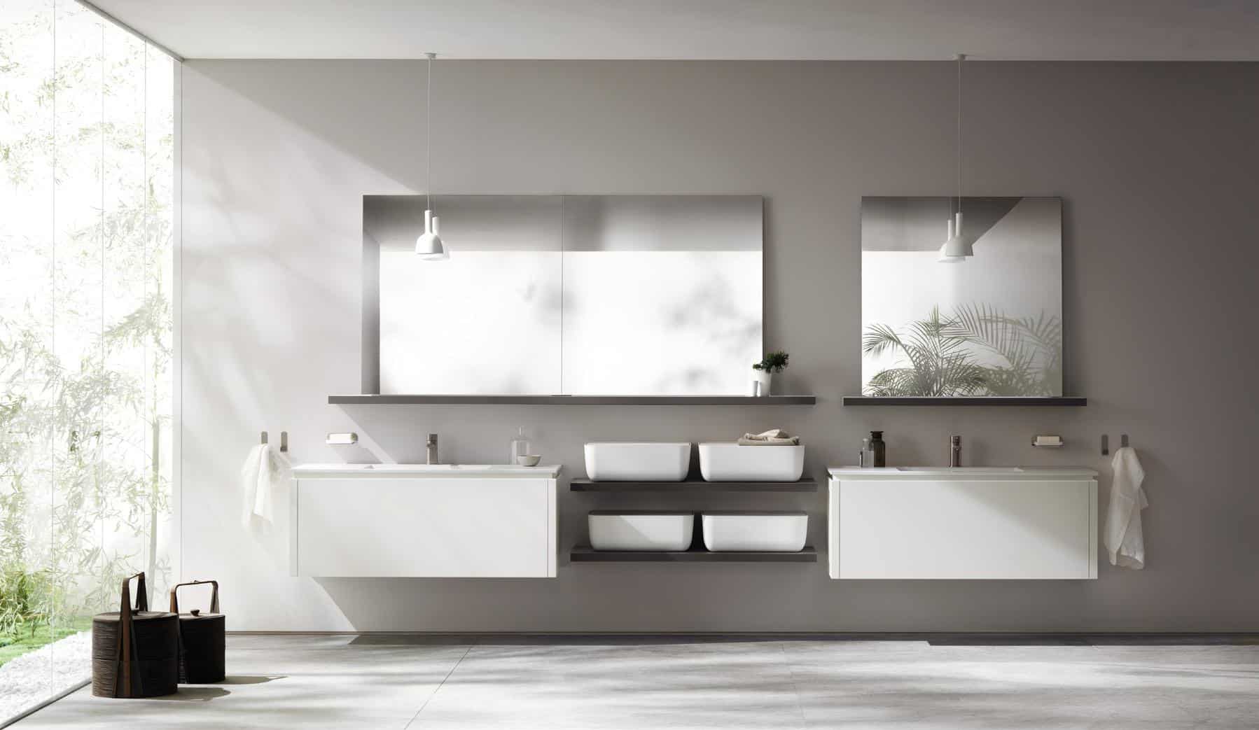 Modern bathroom with two sinks, large mirrors, and minimalistic decor.