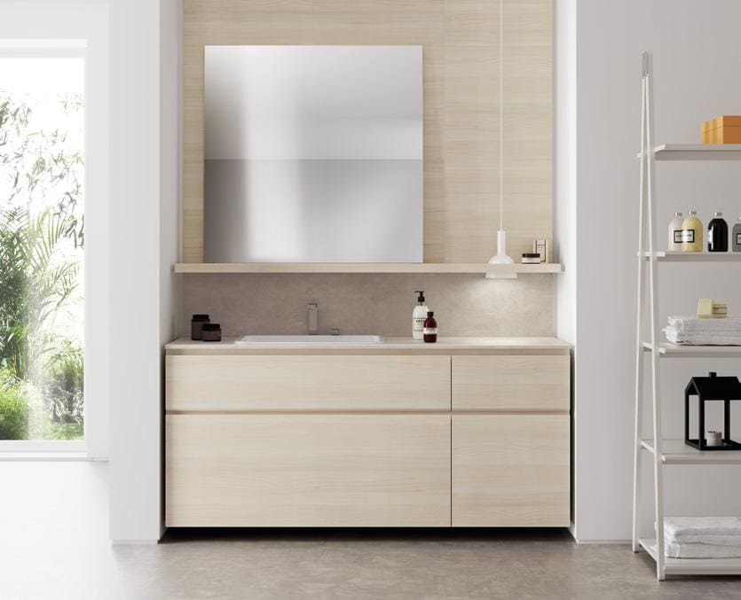 Modern bathroom interior with a large mirror, light wood vanity, countertop sink, and shelving unit with towels and toiletries.
