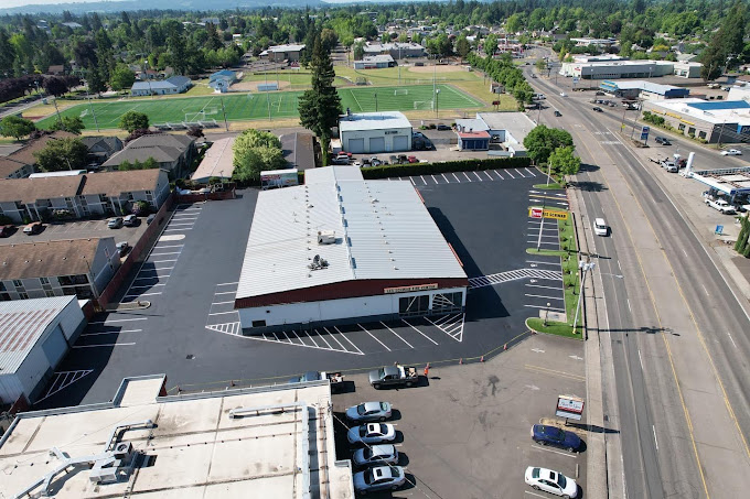 Legacy Paving shows strong, smooth asphalt work for a busy business near homes and local activities.