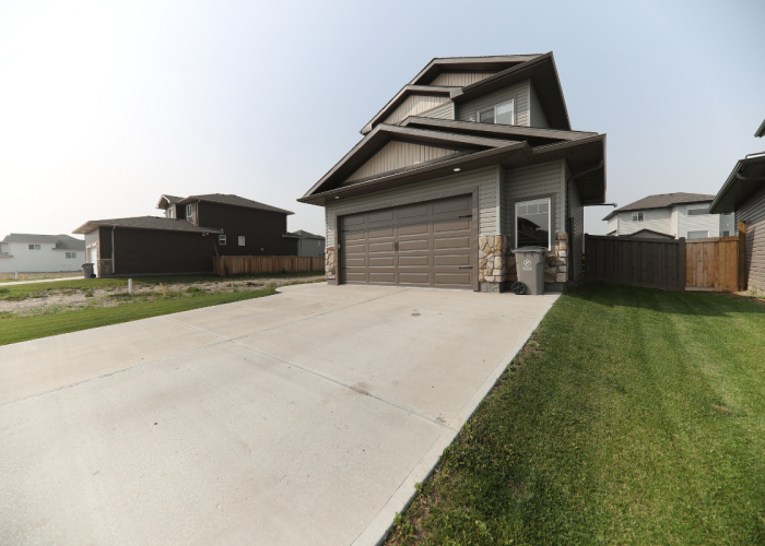 A neat home with a smooth, new driveway shows Legacy Paving’s skill in making welcoming spaces for families.