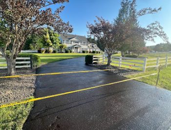 A smooth new driveway by Legacy Paving shows quality work and safety, inviting you to a neat home in a nice neighborhood.