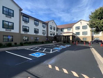 Legacy Paving shows a well-paved hotel entrance with smooth asphalt and marked parking, suggesting quality work for businesses.