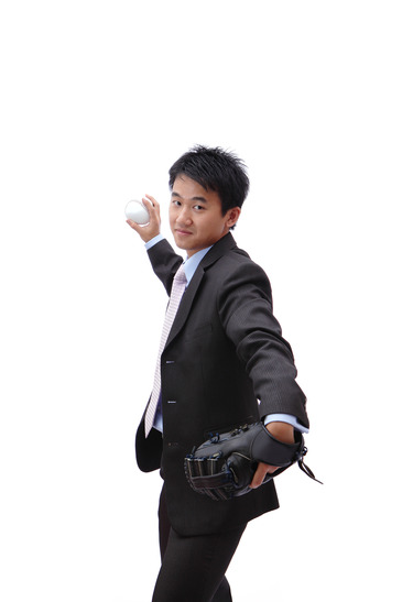Young Asian freelance writer pitching baseball