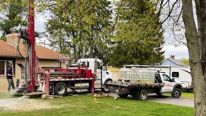 A McCandless Well Drilling rig and team provide water well service for a home in a safe, quiet neighborhood.