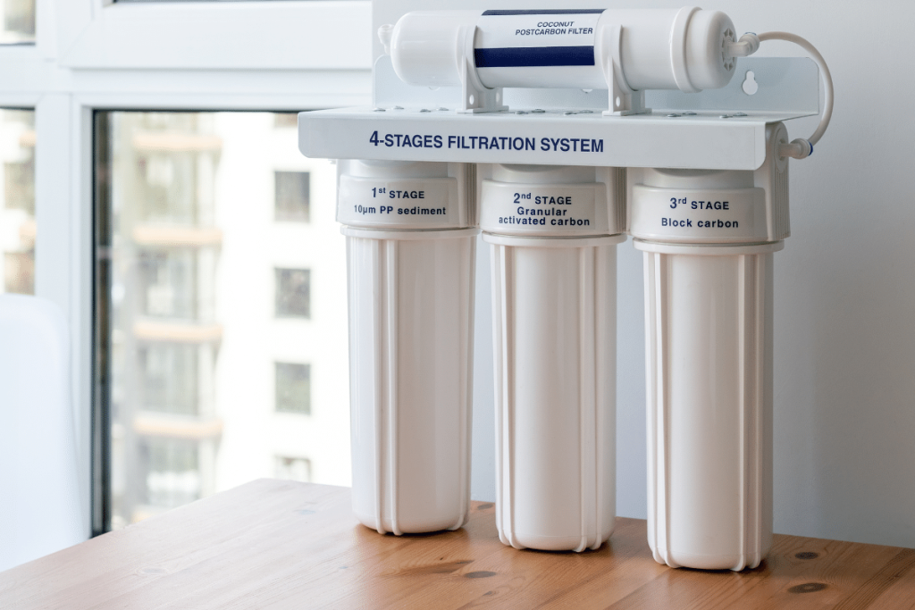 A three-canister water filter labeled 4-Stages Filtration System, showing its made for strong, multi-step water cleaning.