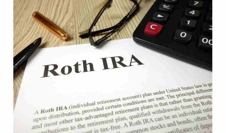 Roth IRA mockup with calculator pen and glasses