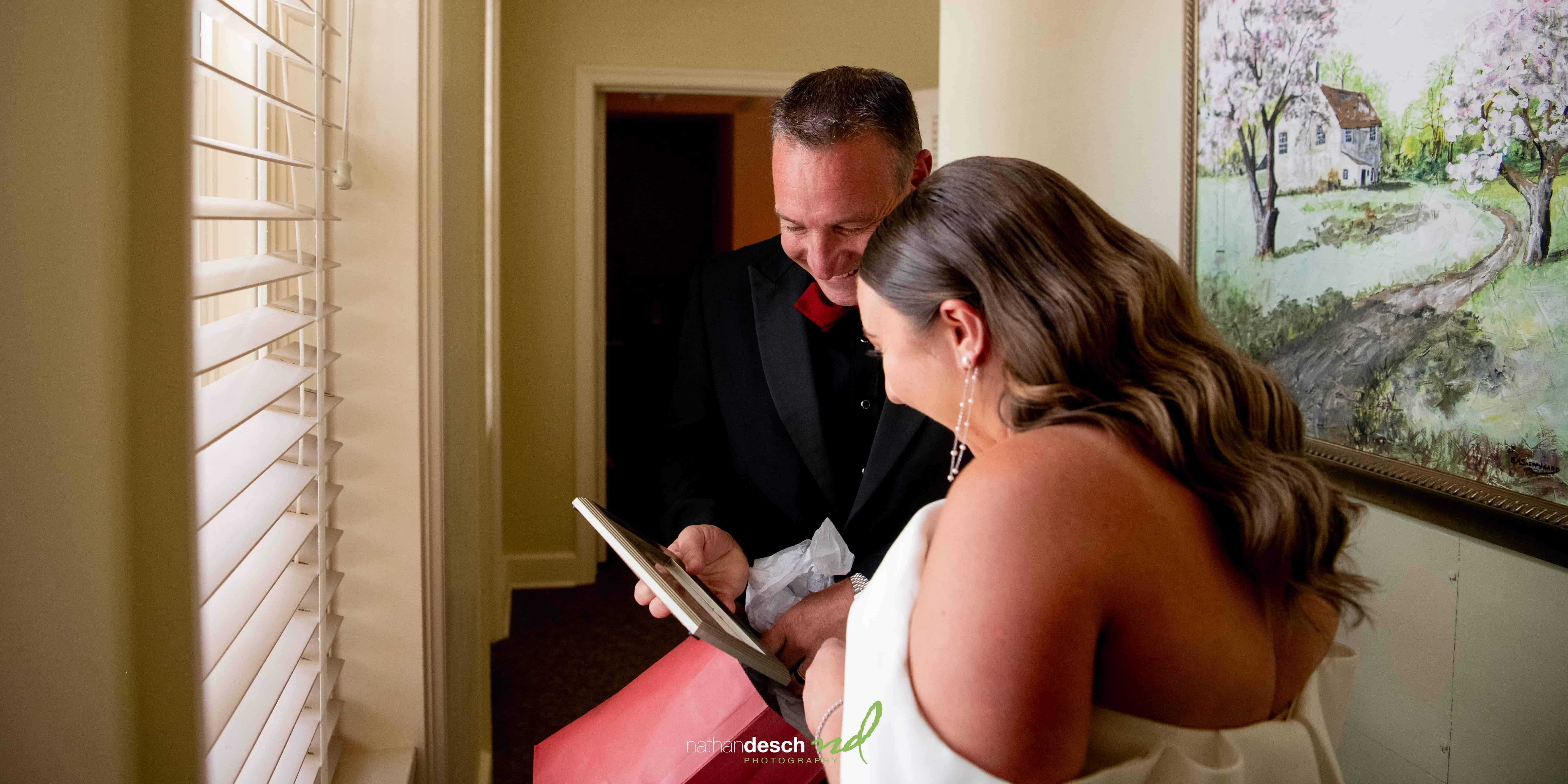 bride and dad looking at memories together