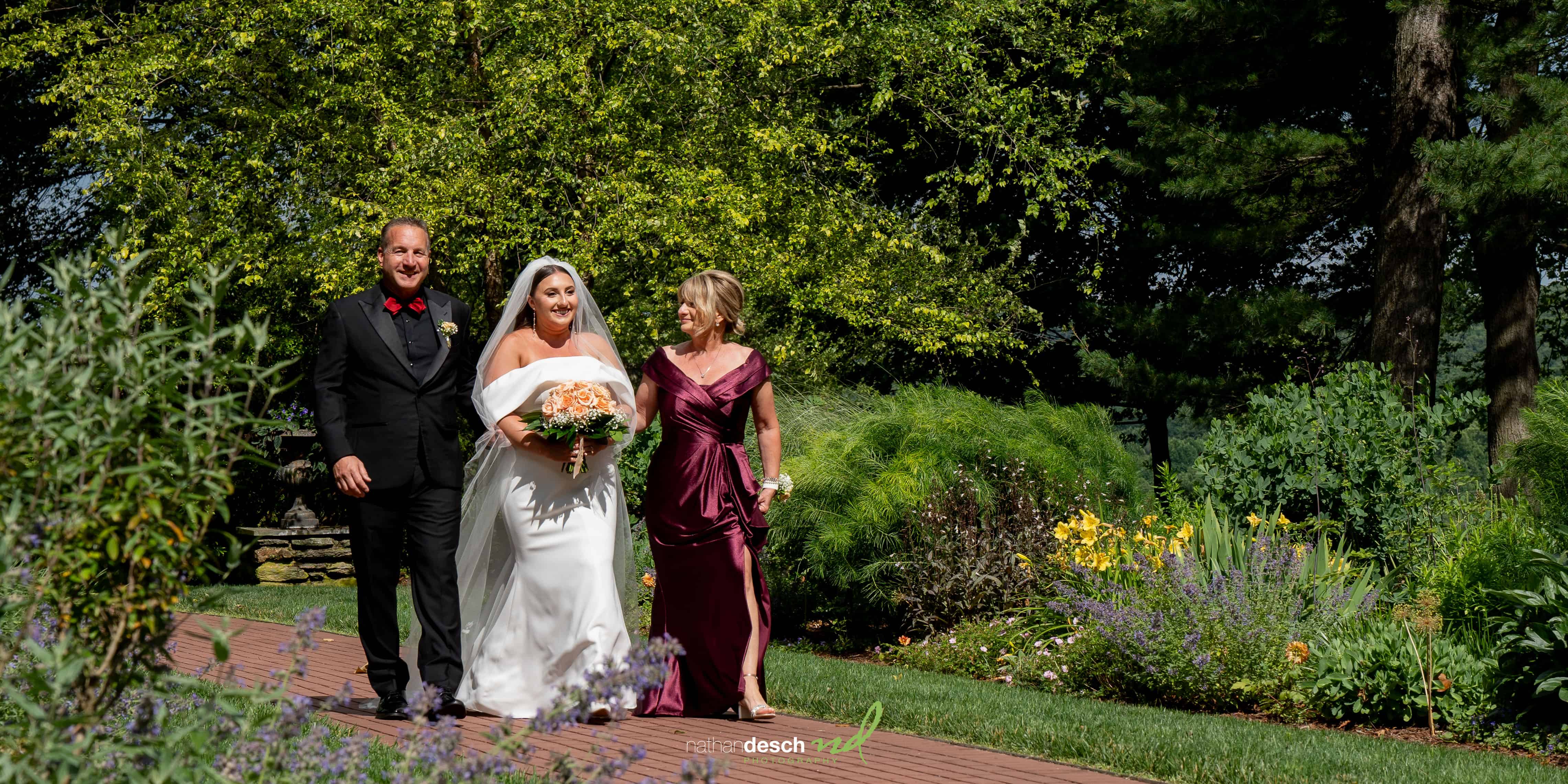 bride coming down aisle with parents