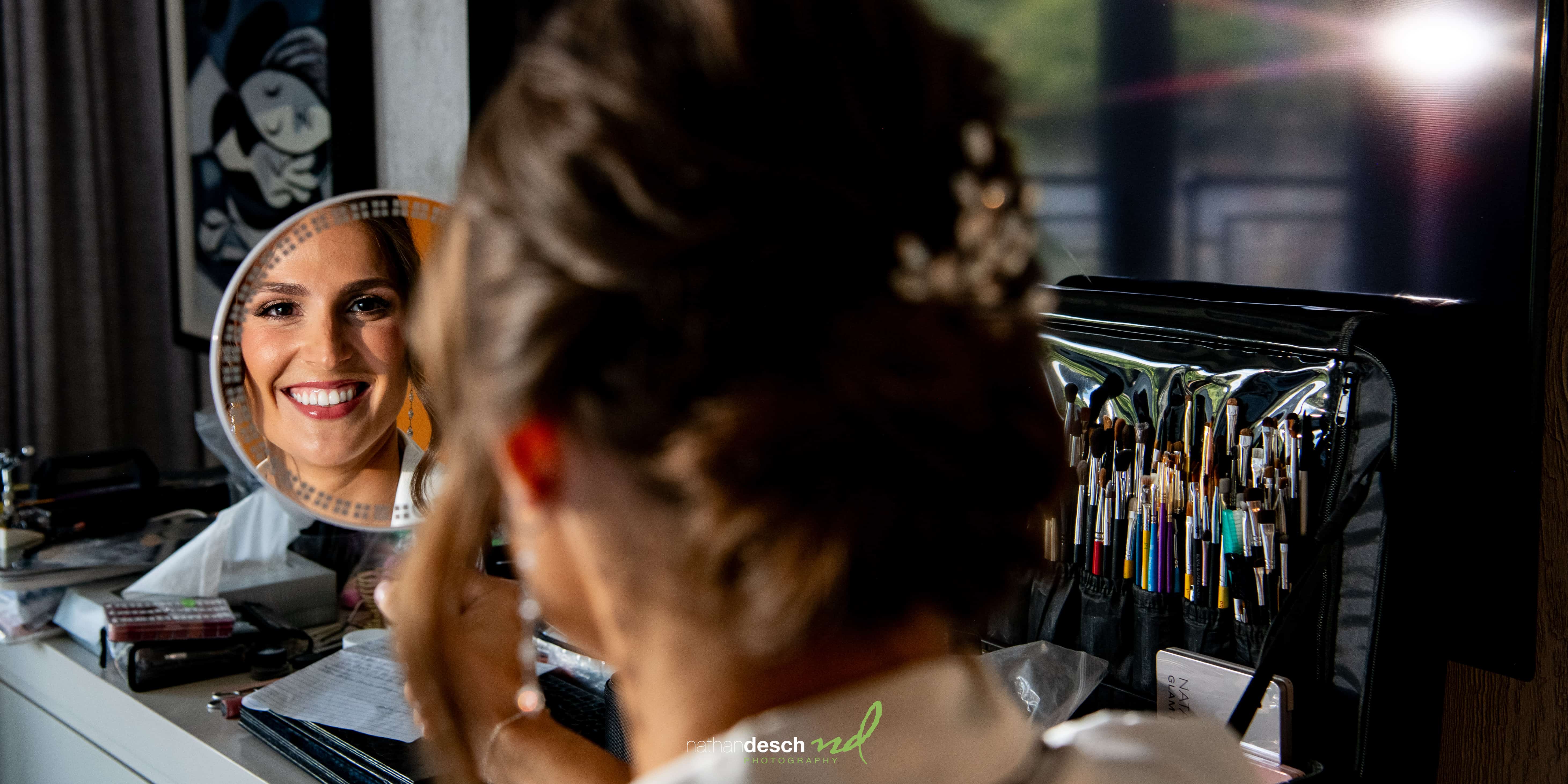 bride getting hair and makeup done