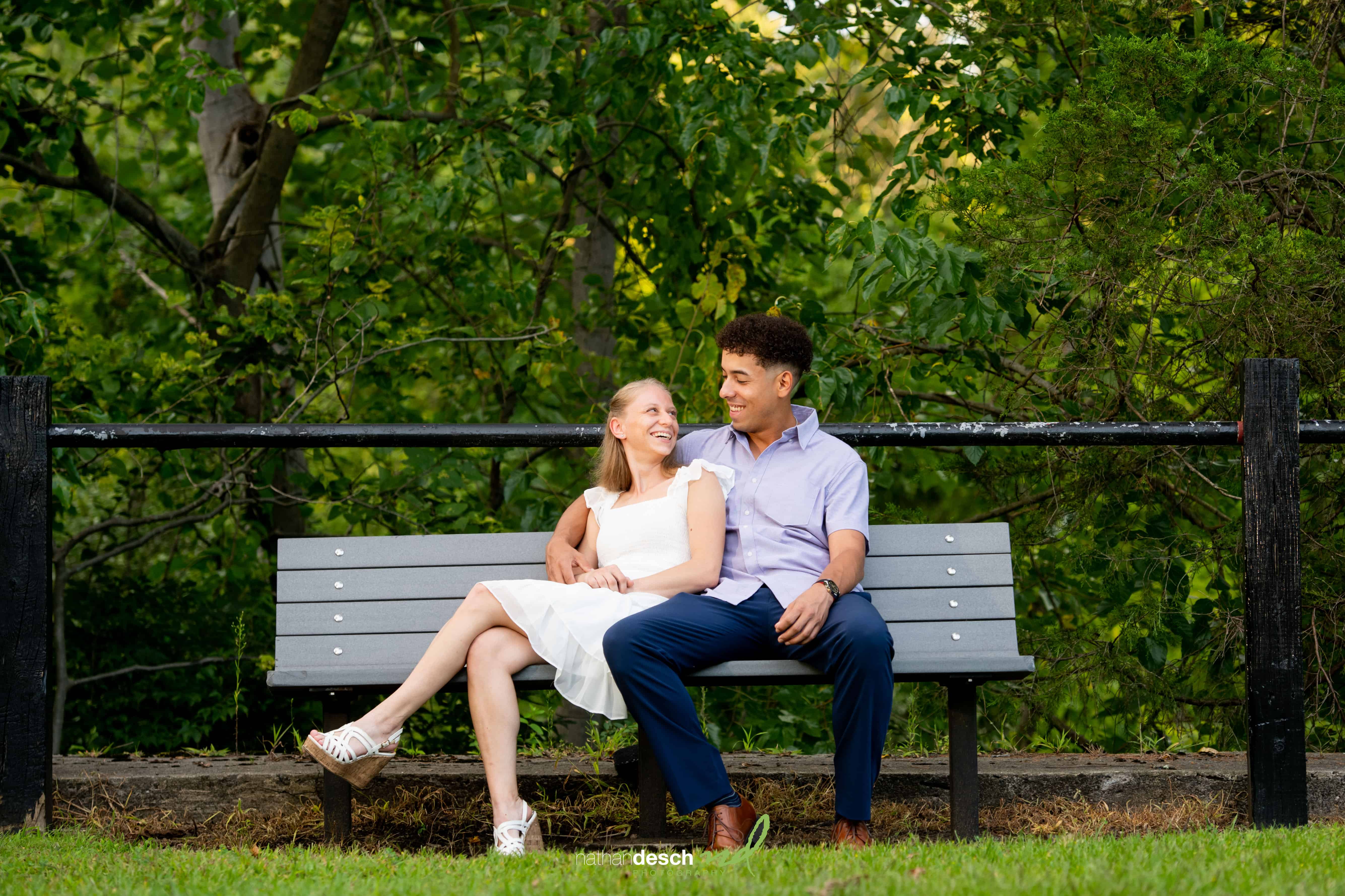 engaged couple on a bench