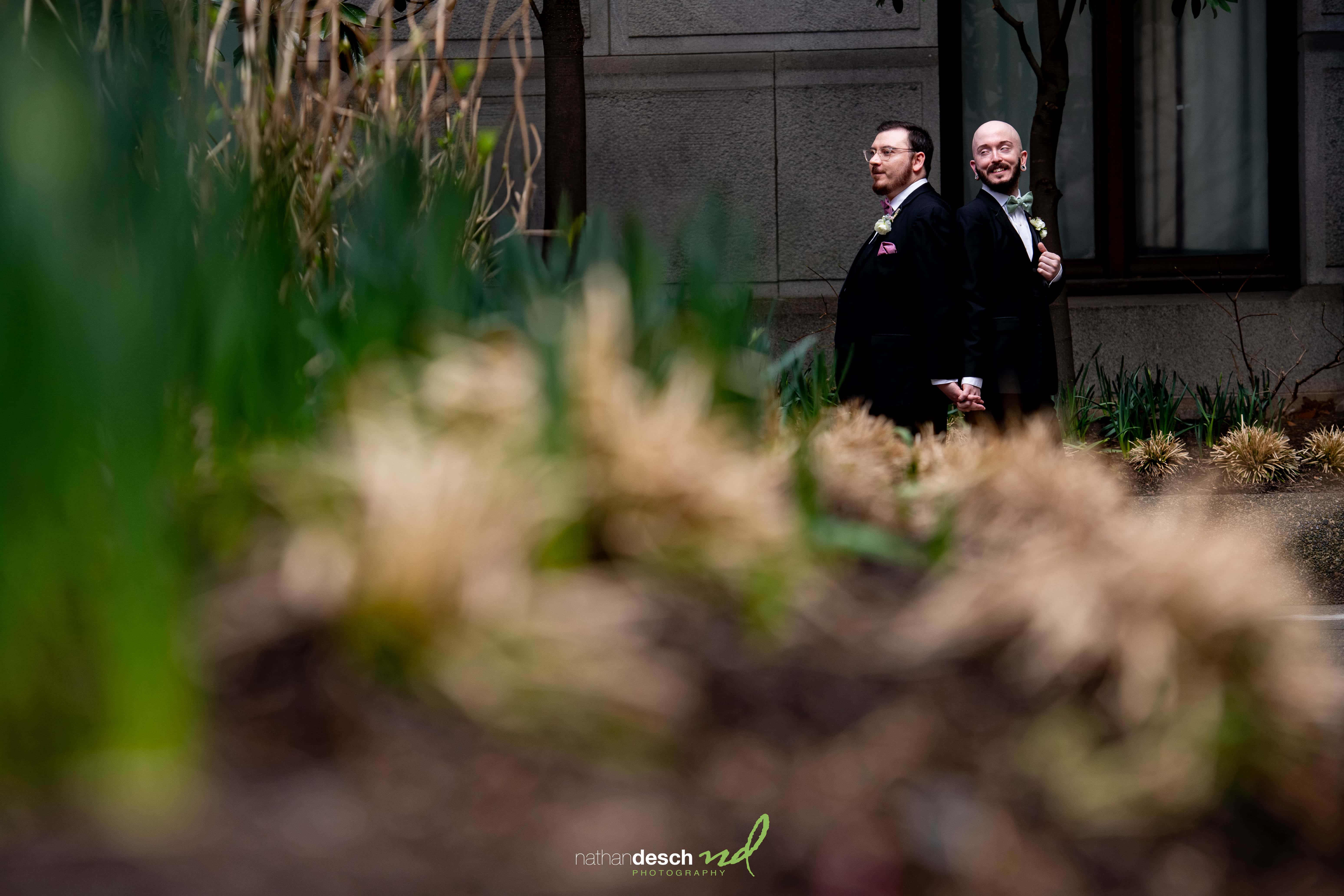 Grooms standing back to back