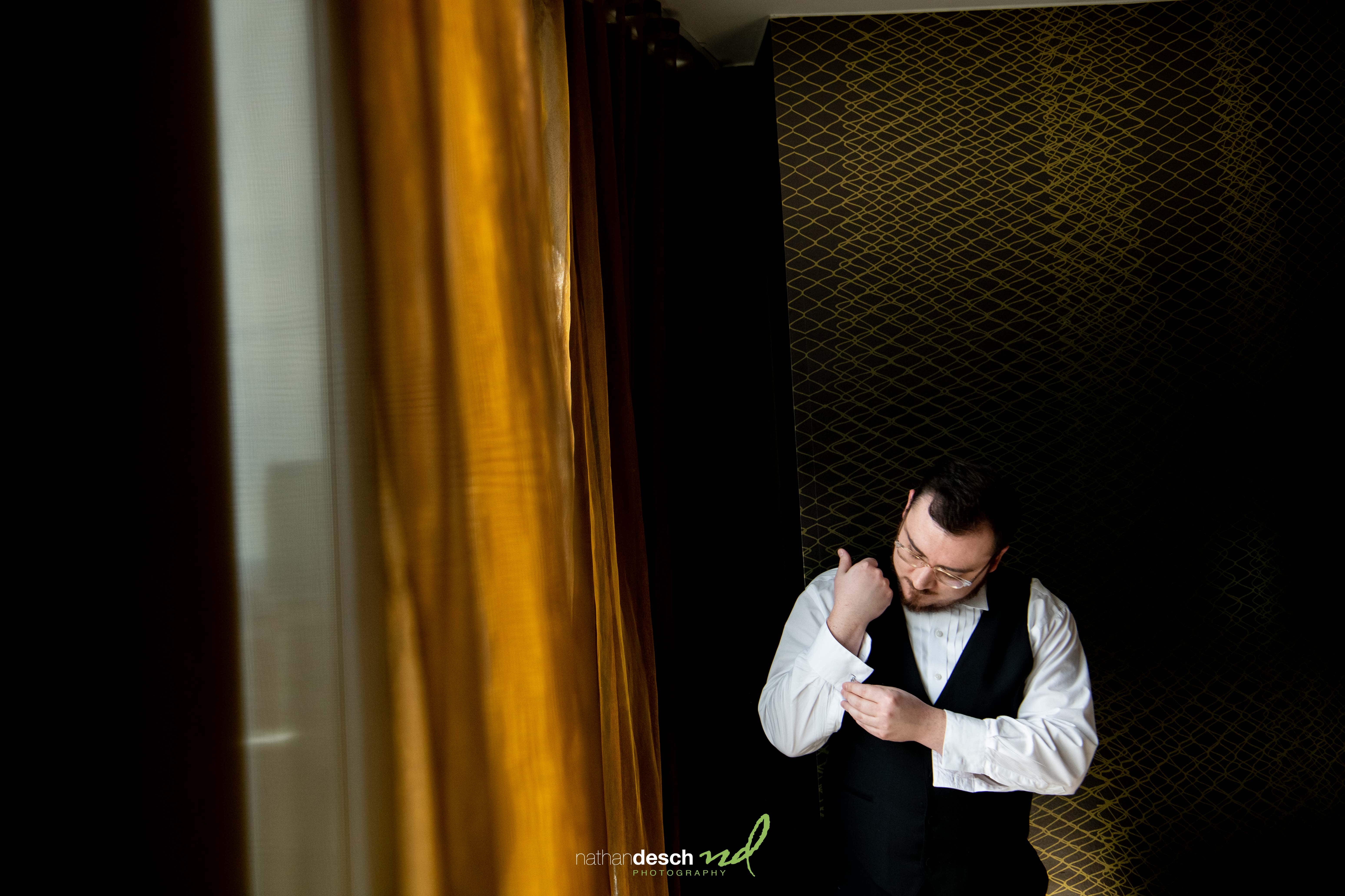 groom getting cufflinks on