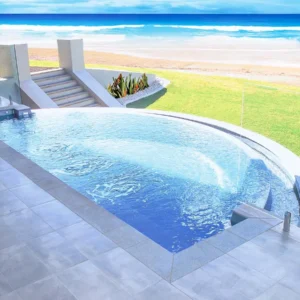 The Horizon™ infinity pool by Northern Colorado Pools offers a relaxing setting with peaceful views of the beach and ocean.