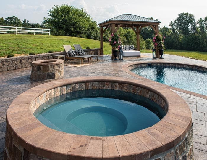 Northern Colorado Pools creates relaxing spaces with a pool, hot tub, and comfy seating for friends and family to enjoy.