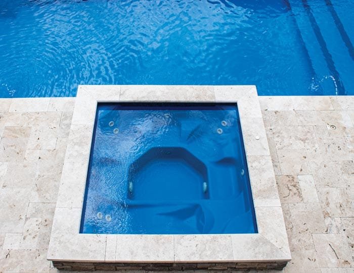 Northern Colorado Pools offers a square hot tub and pool combo, both clean and relaxing, perfect for family fun.