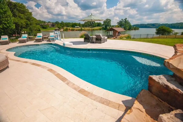 Northern Colorado Pools made a relaxing backyard spot with a pool and lake views for easy, fun outdoor time in Mead, Colorado.
