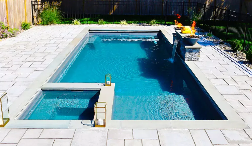 A relaxing backyard oasis by Northern Colorado Pools, designed for easy care and fun with unique features the family will enjoy.