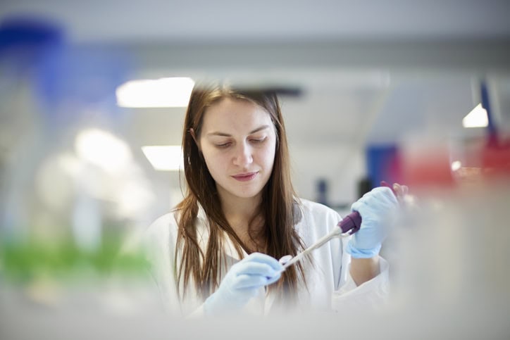 Female science student pipetting in laboratory Female science student pipetting in laboratory