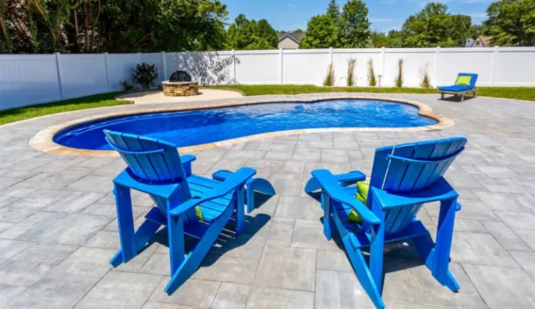 Blue lounge chairs overlooking crystal blue swimming pool