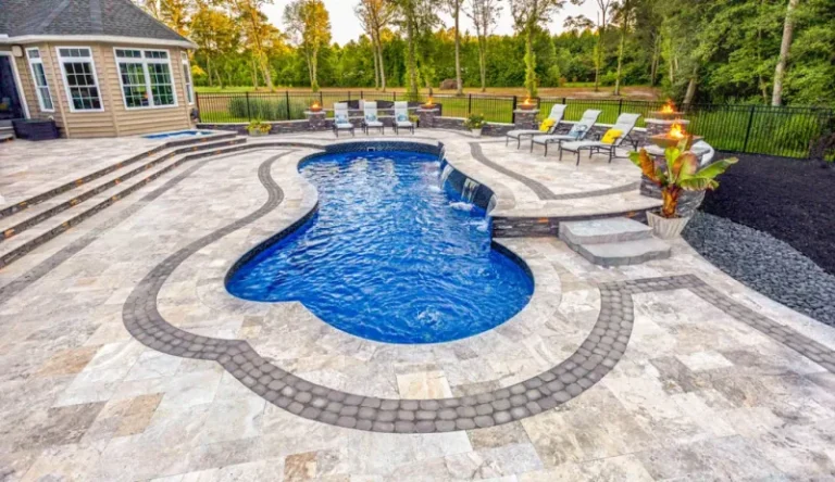 Custom inground pool with mosaic tile and built-in waterfalls