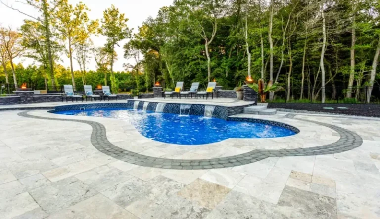 A backyard retreat featuring a pool with mosaic tile inlay.