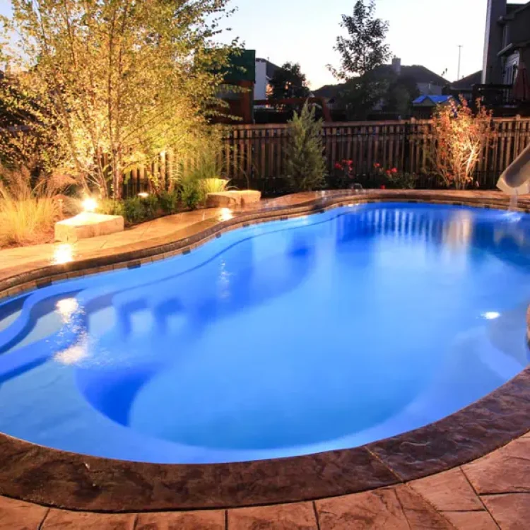 Outdoor pool featuring a built-in slide for kids