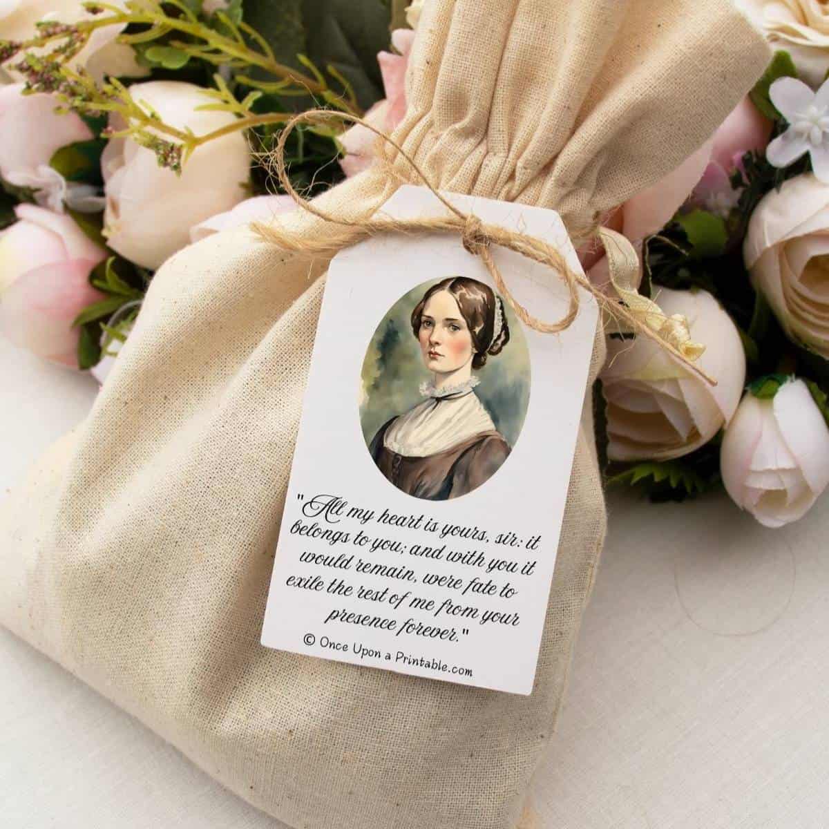 A muslin bag with a Valentine's day gift tag with a vintage-inspired watercolor graphic of Jane Eyre and a quote from her as well.