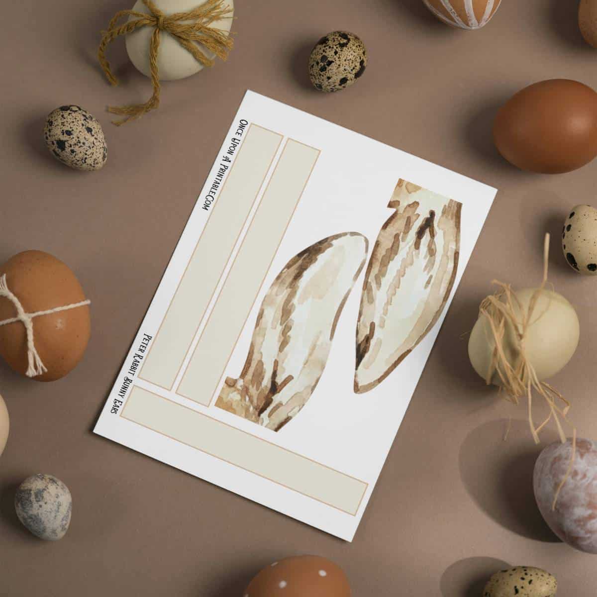Peter Rabbit Bunny Ears printable craft for kids surrounded by colorful eggs.