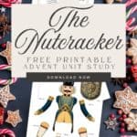Beautiful colorful watercolor graphics of Nutcracker characters in an advent board game displayed on a navy table with gingerbread cookies and candy canes.