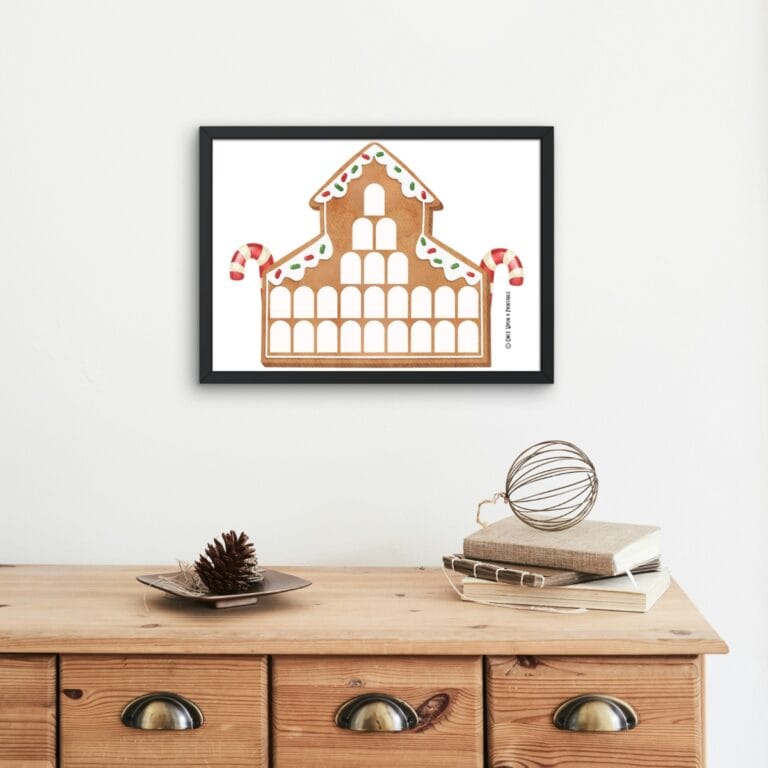 Gingerbread House Christmas countdown calendar framed and hanging above a wooden console.