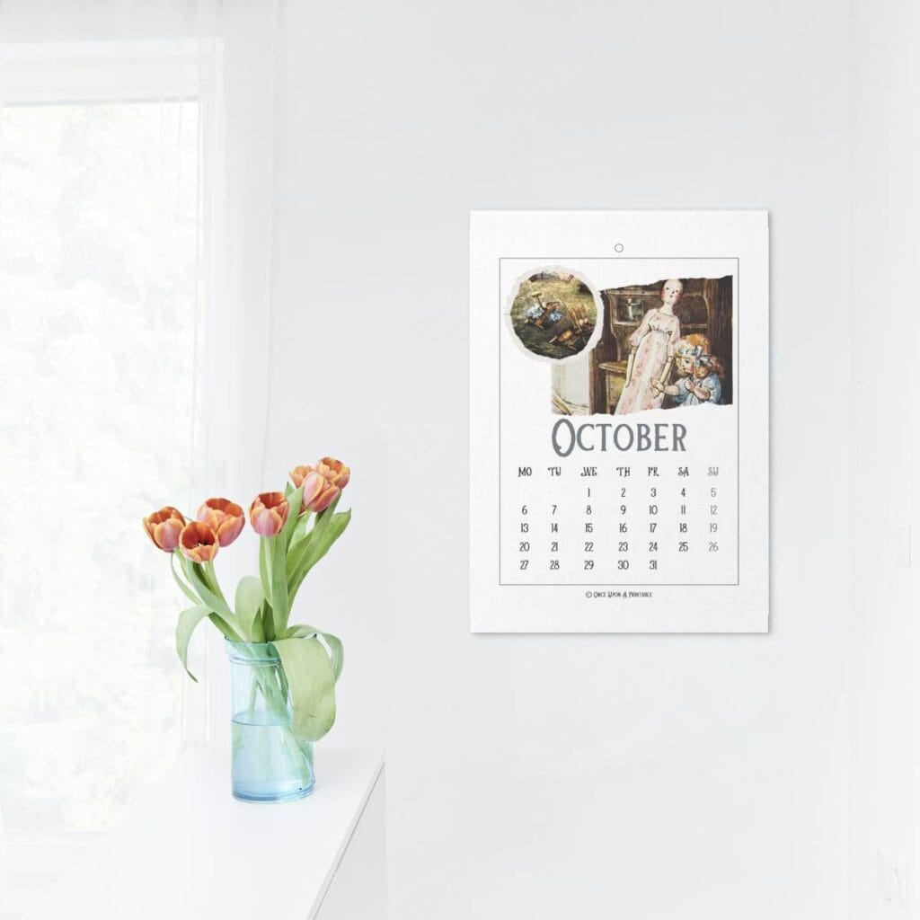 Two bad mice illustrated 2025 calendar in a frame on a wall, displayed with some bright orange tulips in a vase.