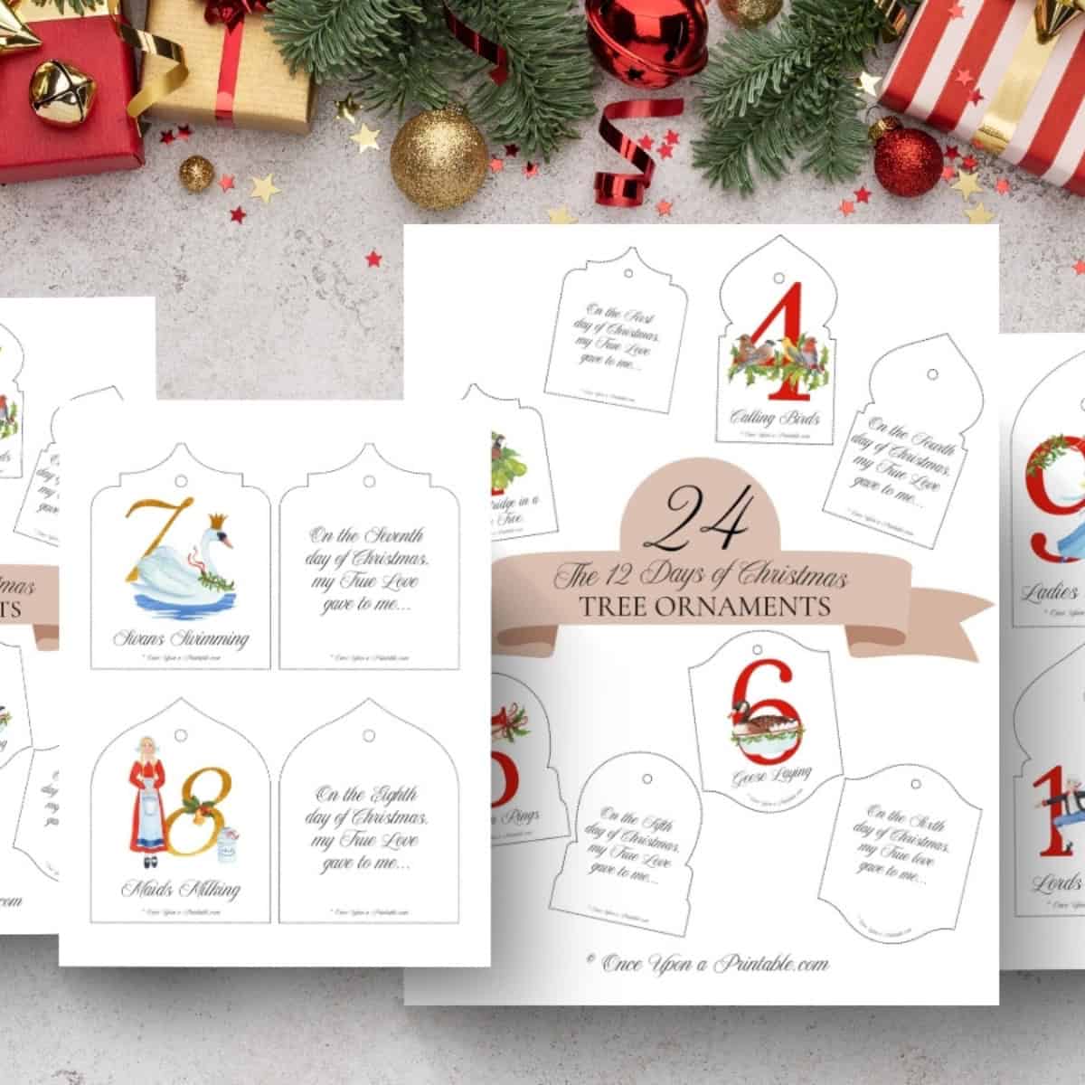 12 Days of christmas tree ornaments two collections of watercolor graphics, printed and displayed on a wooden background with Christmas garland.